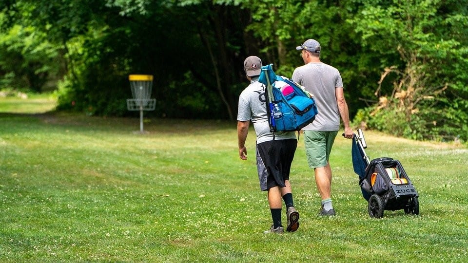 Man Carrying Disc Golf Bags