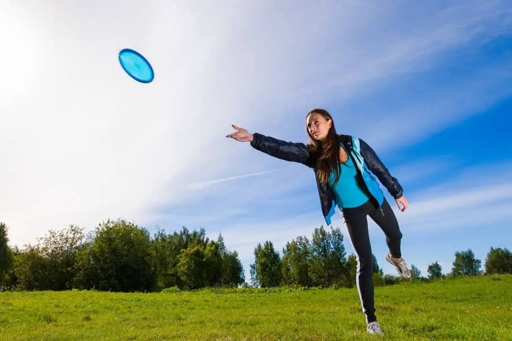 Women Playing Disc Golf in Sunny Day